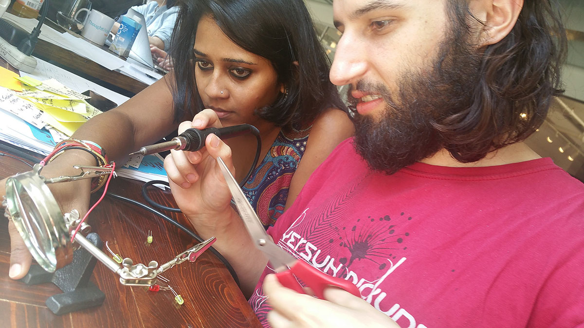 Ria and Chris soldering components